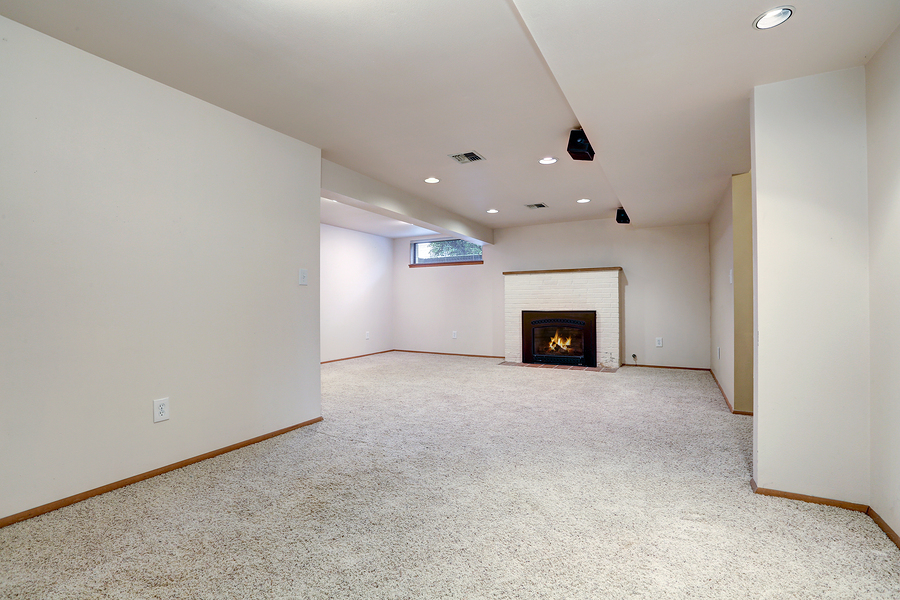 an empty white room with chimney